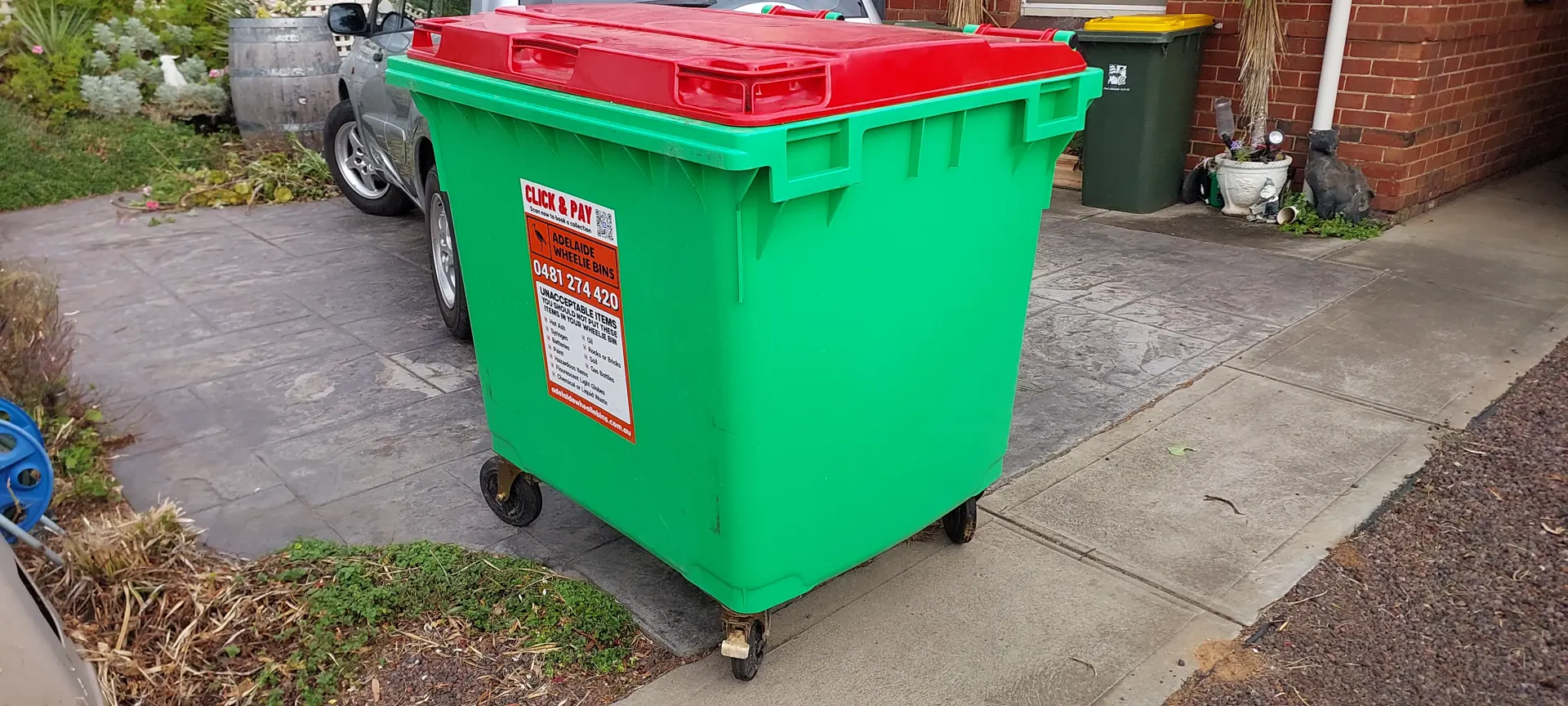 A suburban Adelaide driveway prepared for private wheelie bin collection